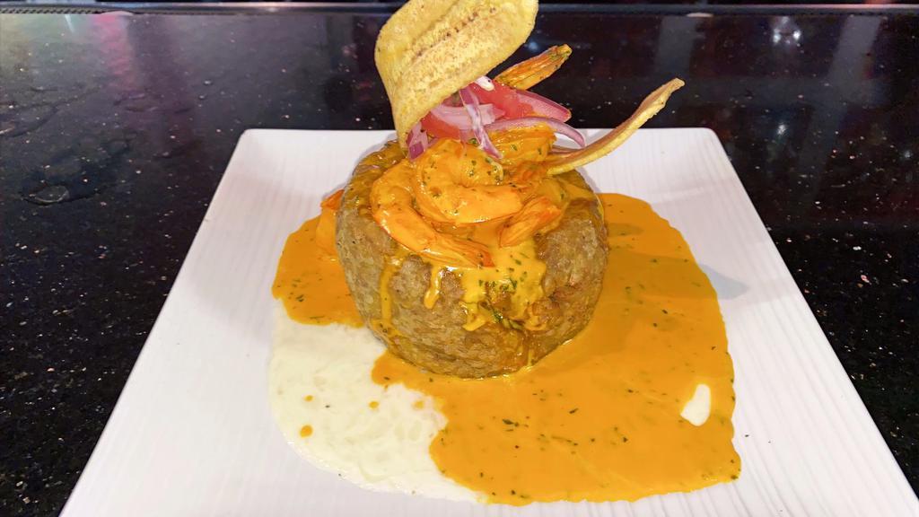 Shrimp Mofongo · Plantains are fried, then mashed with pork rinds, salt, garlic, and oil. Topped with mozzarella cheese sauce & pico de gallo. Served with sautéed shrimp in a choice of eve cream sauce, garlic butter sauce or plain.