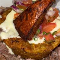Roast Pork Mofongo · Plantains are fried, then mashed with pork rinds, salt, garlic, and oil. Topped with mozzare...