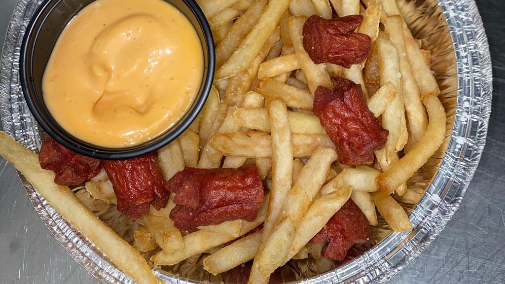 Salchipapas · Thinly sliced pan-fried beef hotdogs and French fries, mixed together with a side of mayo ketchup.