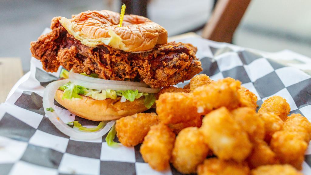 Hot Chicken Sandwich · Spicy. Crispy chicken thigh, secret herbs and spices, buttermilk mayo, lettuce, onion and pickles on a potato bun. Served with a side of tater tots.