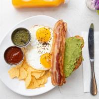 Sunny Avocado Croissant · Sunny side up eggs, bacon, mashed avocado, cheddar, side salad