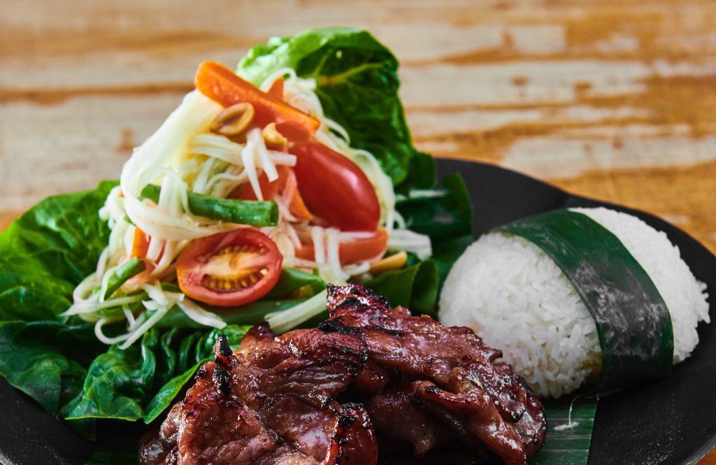 Grilled Pork With Papaya Salad  · Grilled pork marinated with bbq sauce. Green papaya, tomatoes, string beans, carrot and peanut with lime dressing served with sticky rice.