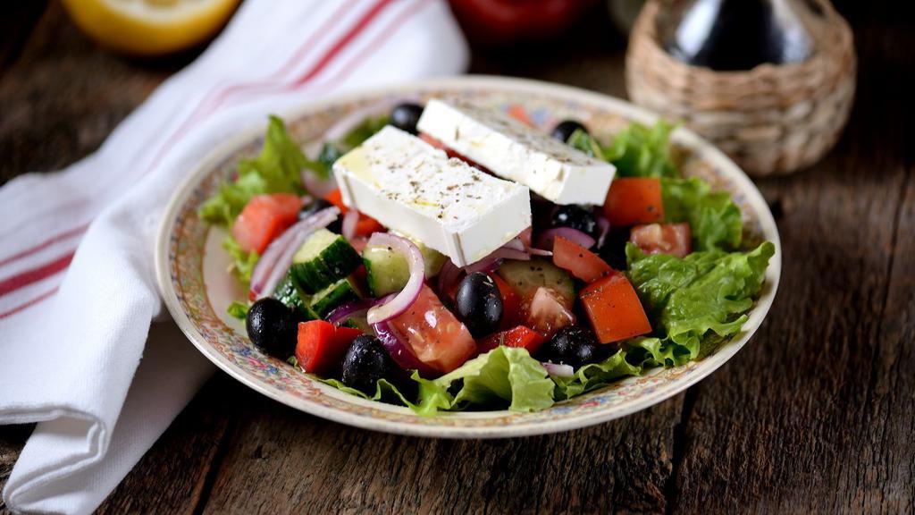 Greek Salad · Crispy romaine lettuce, feta cheese, stuffed grape leaves, tomatoes, red onions, kalamata olives, cucumbers and bell peppers.