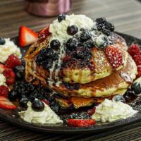 Blueberry Pancakes · Homemade blueberry compote,
whipped cream, maple syrup,
hibiscus syrup, seasonal fruit