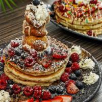 Fried Oreo Pancakes · Crumbled oreo pancakes, deep fried
oreos, whipped cream, hibiscus syrup,
maple syrup, season...