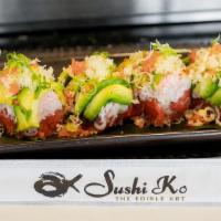 Phoenix Roll · Avocado wrap around spicy tuna and kani salad, topped with crunchy flakes, masago, and scall...