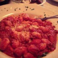 Gnocchi Bolognese · Homemade gnocchi pasta tossed with ground veal, beef and sausage in a tomato sauce with a to...