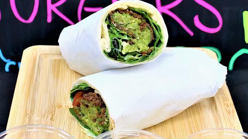 Falafel Wrap · Falafel, it self made out of garbanzo beans, onion, parsley, garlic and spices, in the wrap along with falafel, lightly dressed spring mix green salad,tomatoes, onion and tahini sauce