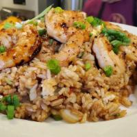 Arroz Chaufa De Pollo · Fried rice mixed with vegetables and eggs.