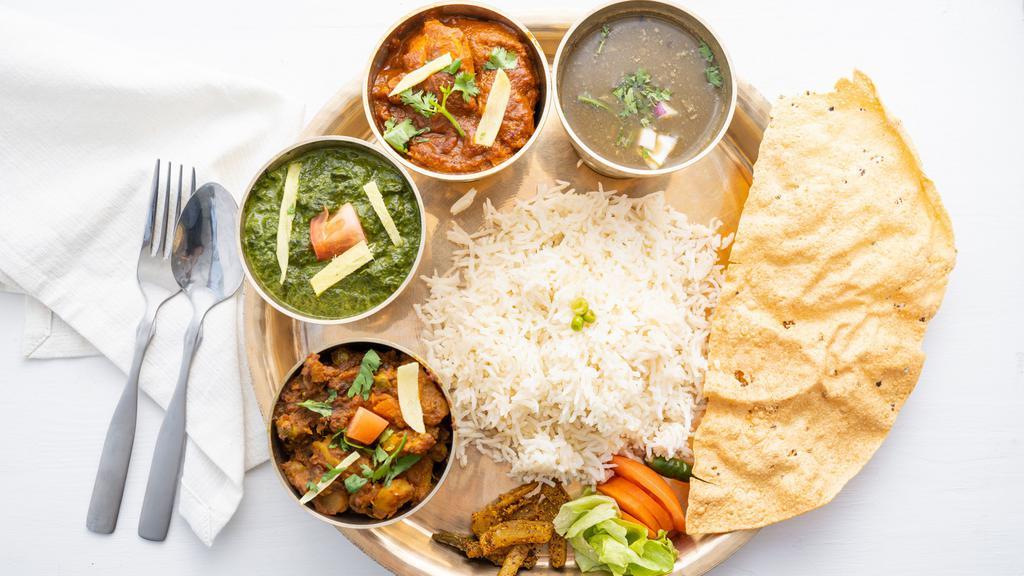 Daal Bhaat Massu · Typical Himalayan platter with a choice of veg, chicken, lamb or goat this platter is served with mustard green spinach, vegetable and traditional black lentils, salad, achar, papad and rice.