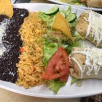 Chimichangas De Pollo O Bistec /  Grilled Flour Taco Filled With Chicken Or Beef` · Servidos con arroz y frijoles / with rice and beans