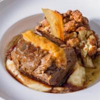 Braised Short Ribs Of Beef · With truffle potatoes and roasted cauliflower.