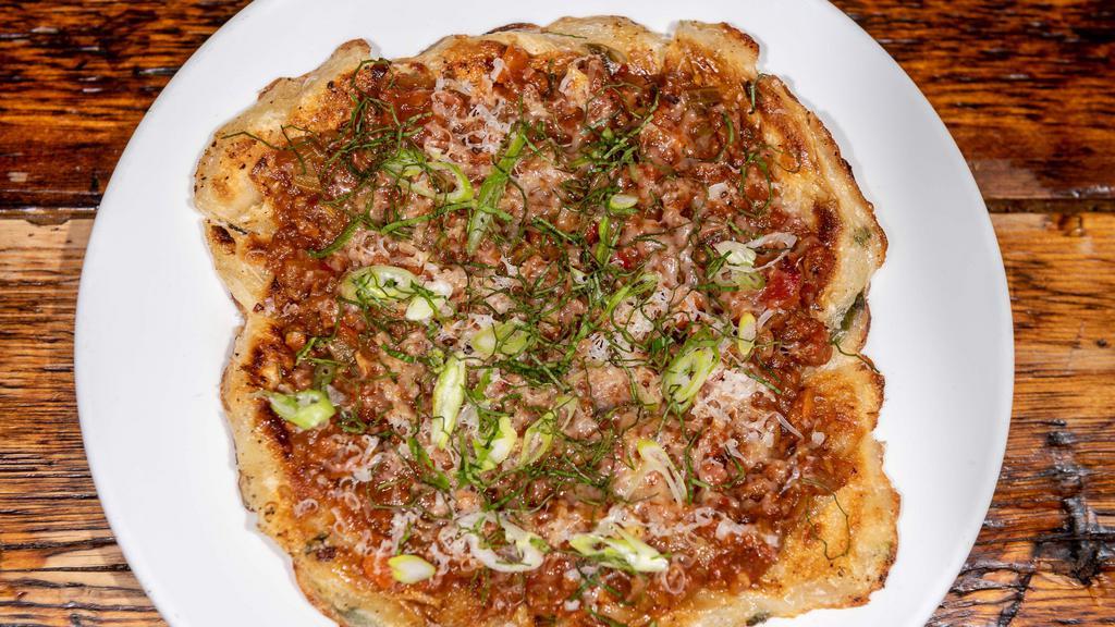 Scallion Pancake Pizza · Our crispy and chewy Taiwanese scallion pancake topped with your choice of either grass-fed beef or veggie bolognese sauce, topped with grass-fed raw Cheddar and garnished with fragrant Thai basil and scallion. 9