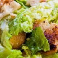 Caesar Salad · Crispy romaine lettuce, carrots, tomato, black olives and croutons topped with our creamy Ca...