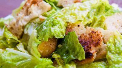 Caesar Salad · Crispy romaine lettuce, carrots, tomato, black olives and croutons topped with our creamy Caesar dressing.