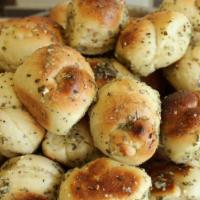 Garlic Knots · A classic snack, our garlic knots are strips of pizza dough tied in a knot, baked, and then ...