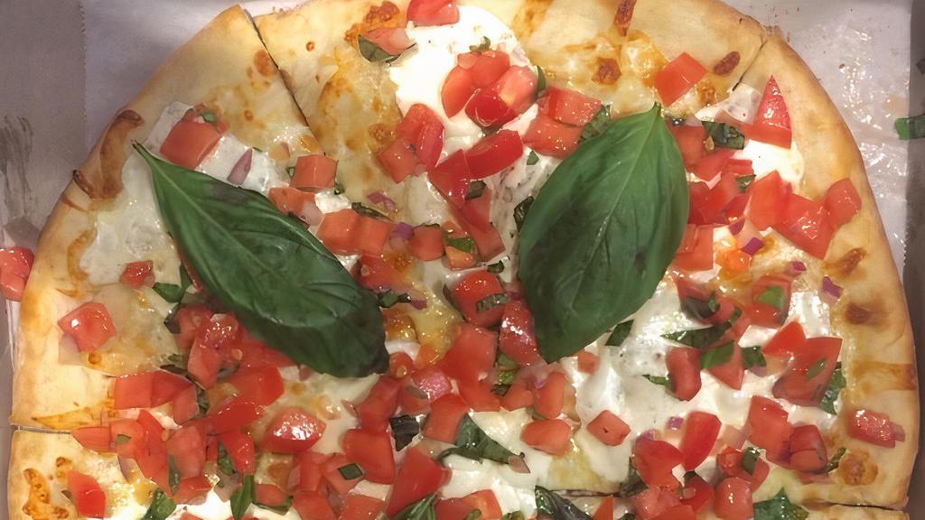Bruschetta Pizza · Topped with fresh tomatoes, basil, garlic, and mozzarella cheese.
