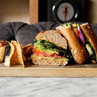 Vegan Veggie Sandwich · Spicy hummus, sliced avocado, tomatoes, roasted carrots, cucumbers, red onion, baby kale spr...