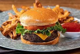 The Burger Deluxe · 8oz Angus burger, lettuce, tomato, american cheese served with fries