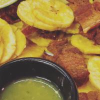 Chicharron Ahumado · Smoked pork belly with green plantains and yuca fries.