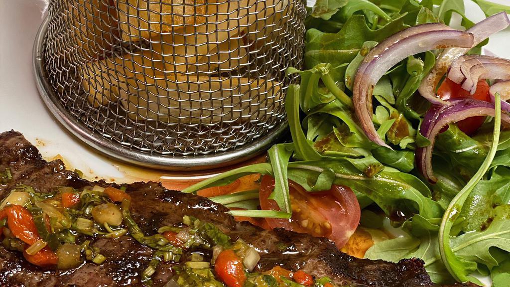 Churrasco · Grilled angus skirt steak with chimichurri sauce, yucca fries and arugula salad.