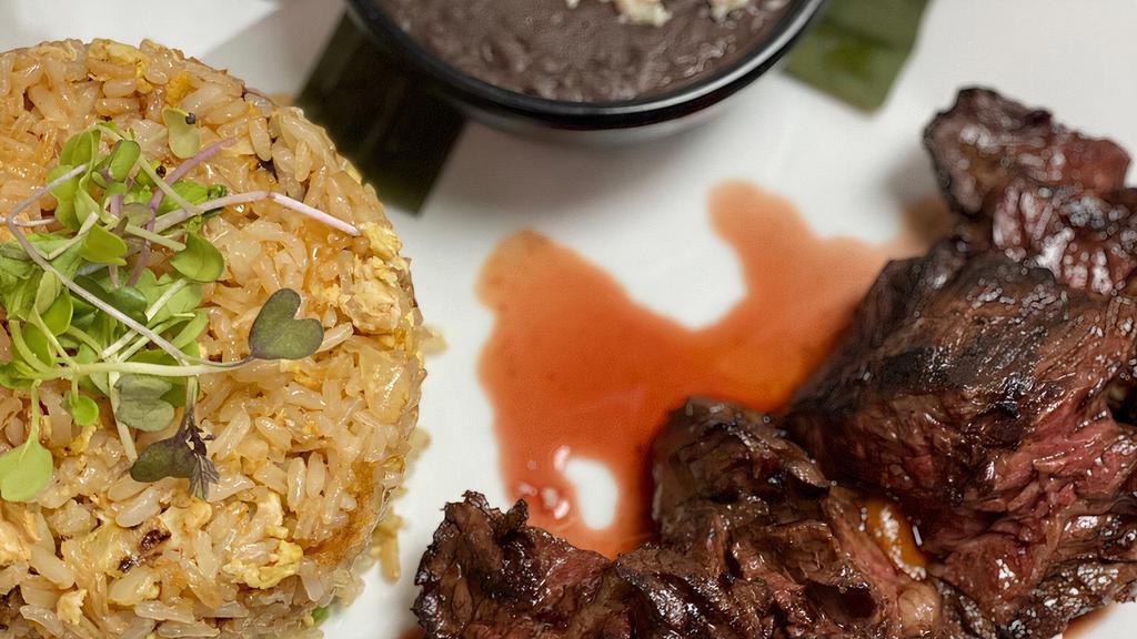 Carne Asada De Tampico · Grilled black angus hanger steak in ancho sauce. Served with chefs Latin fried rice.