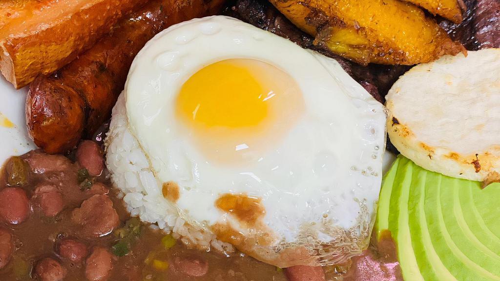 Bandeja Paisa · Typical platter from Colombia, served with rice, beans, steak, sausage, pork skin, avocado, egg and arepa.