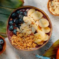 Ocean Blueberry Bowl · Acai bowl topped with  granola, bananas, blueberries, almond slices, and honey.