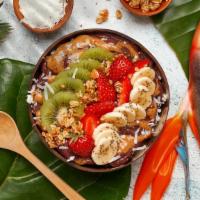 Strawberry Almond Joy Bowl · Acai bowl topped with  granola, strawberries, kiwi, banana, shredded coconut, chia seeds, al...