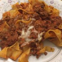 Pappardelle Alla Bolognese · Flat ribbon pasta in a veal and beef ragu.