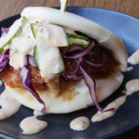 Two Crispy Chicken Buns · Two baos with panko fried chicken, cabbage, black sesame seeds, togarashi, and sauce