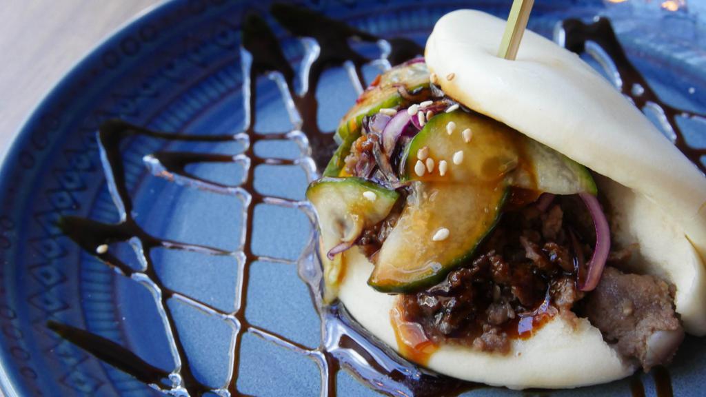 Two Bulgogi Beef Buns · Two baos with thinly sliced korean style beef, cabbage, black sesame seeds, and sauce