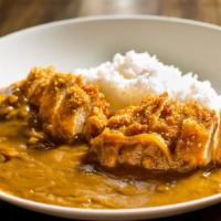 Chicken Cutlet Curry · Rice bowl topped with breaded chicken breast and onion curry.