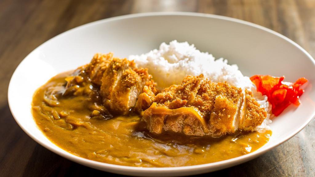 Chicken Cutlet Curry · Rice bowl topped with breaded chicken breast and onion curry.