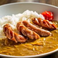 Pork Sausage Curry · Rice bowl topped with pork sausage and onion curry.