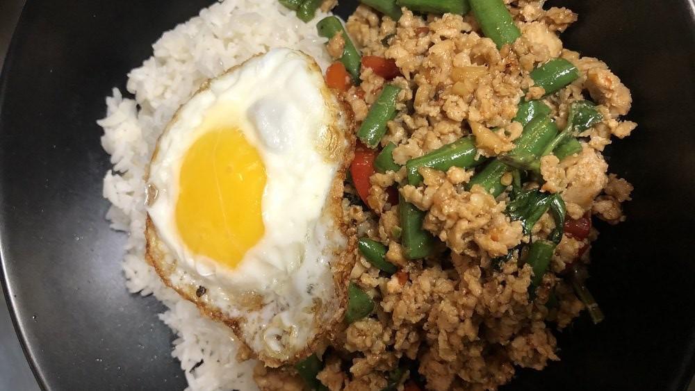 Kra Prow Kai Dow · Medium spicy. Minced chicken or pork, red bell pepper, string bean, garlic, basil, chili topped with a fried egg over rice.