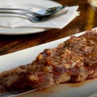 Nam Tok Nuer (Sirloin Steak) · Medium spicy. Grilled sliced sirloin steak, shallot, scallion cilantro, mint, roasted rice w...