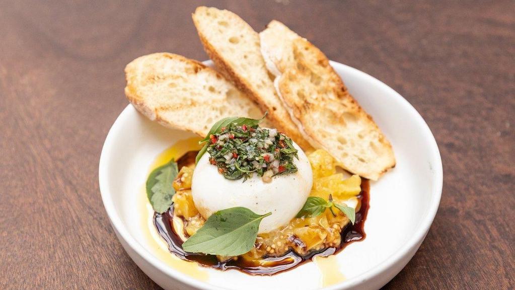 Burrata · A 4oz ball of locally handcrafted burrata cheese (mozzarella with a creamy center), laid upon a sweet and sour pineapple jam. Topped with a gremolata of thai basil, ginger and shallots, reduced tondo balsamic and fresh crushed black pepper. Accompanied by local baguette, gently kissed on the grill.