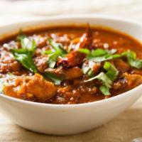 Chicken Curry · Chicken pieces cooked in onion, tomato gravy with spices.