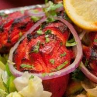 Tandoori Chicken · Chicken leg pieces spiced & marinated in yogurt sauce and cooked on skewers in clay oven.