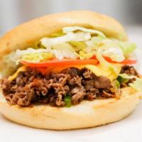 Philly Cheesesteak · Shredded steak with sauteed onions, peppers, cheese, lettuce, and tomatoes.