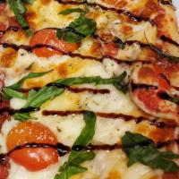 Margherita Flatbread Pizza · Topped with Mozzeralla cheese, Fresh Basil, with a Sweet Balsamic Glaze