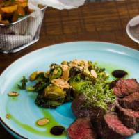 New York Strip Perfection · Skhug marinated topped with shallots red wine reduction. Served with brussels sprouts OR you...