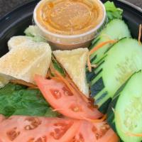 Thai Salad · Mixed greens, cucumbers, tomatoes, red onions, and tofu served with peanut dressing.