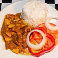 Curry Goat · Served your choice of White Rice or Rice and Peas, Plantain, and Vegetables