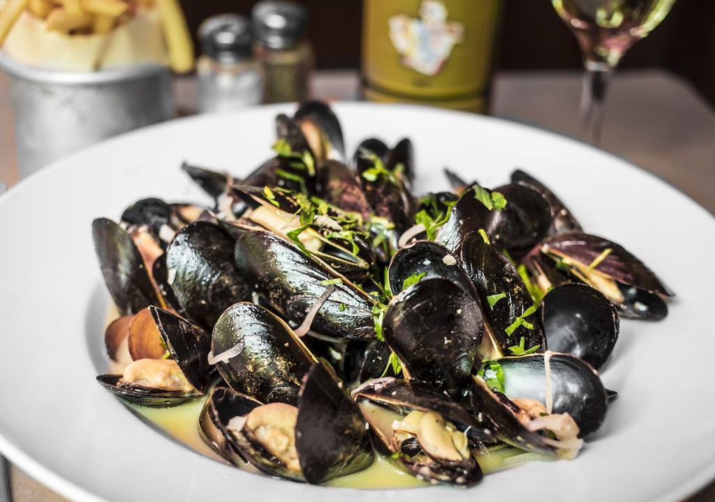 Mussels Marinières Main Course · Prince Edward Island mussels served with roasted garlic, shallots, parsley and white wine sauce.Includes a side of your choice and a sauce of your choice