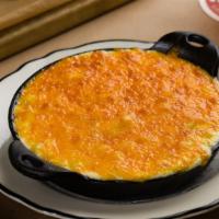 Macaroni And Cheese Gratiné · With melted cheddar cheese and a touch of cream.