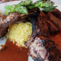 Rack Of Lamb · Grilled rack of lamb served with rice pilaf and grilled asparagus.