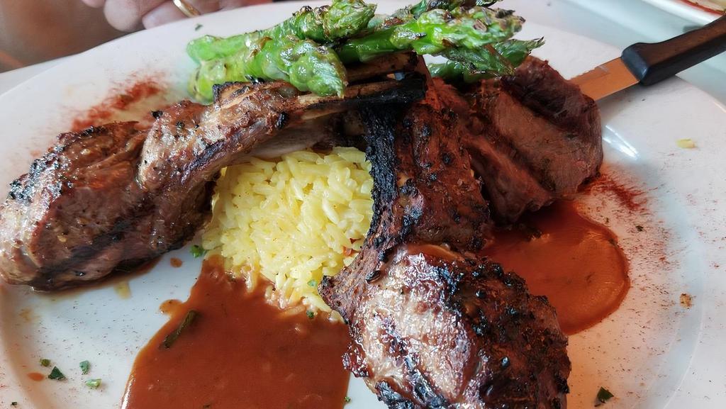 Rack Of Lamb · Grilled rack of lamb served with rice pilaf and grilled asparagus.