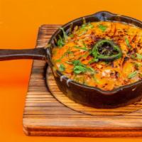 Queso Fundido · Fundido mexican chorizo, diced tomato and onions mixed with a blend of pepperjack, oaxaca, a...